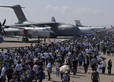 Visitors attend the 12th China International Aviation and Aerospace Exhibition, also known as Airshow China 2018, Tuesday, Nov. 6, 2018, in Zhuhai city, south China's Guangdong province. (AP Photo/Kin Cheung)